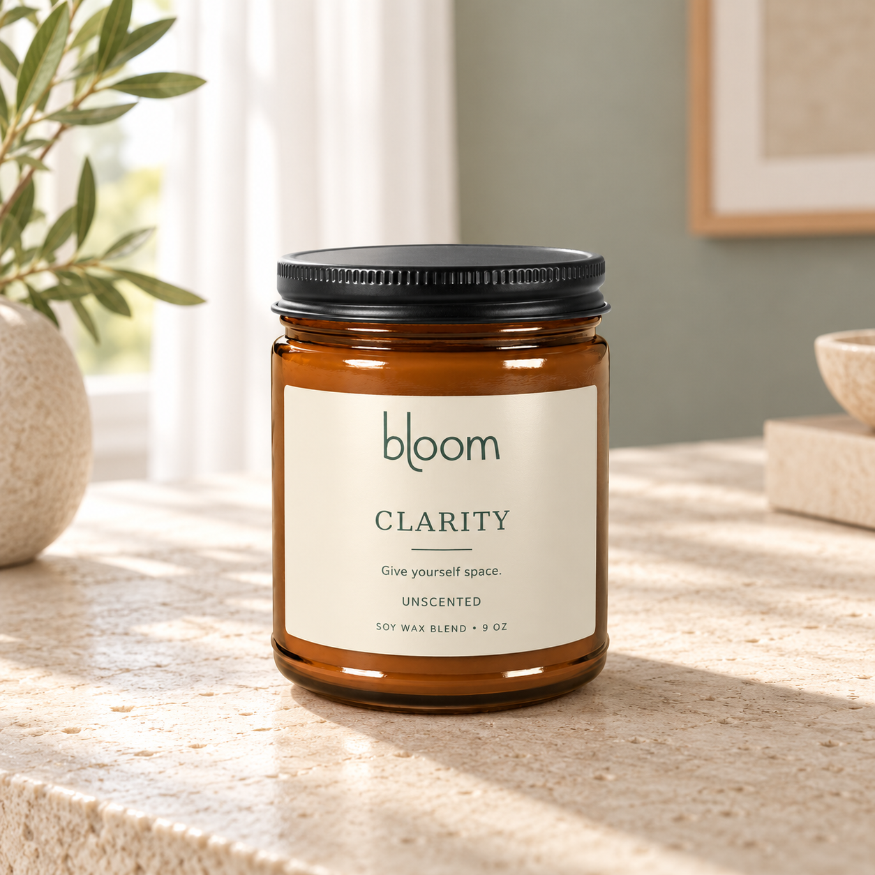 Bloom Clarity 9 oz unscented candle styled on a stone table in a home setting.