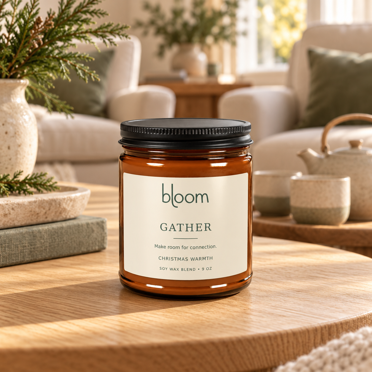 Bloom Gather 9 oz Christmas Warmth candle styled beside tea in a home setting.