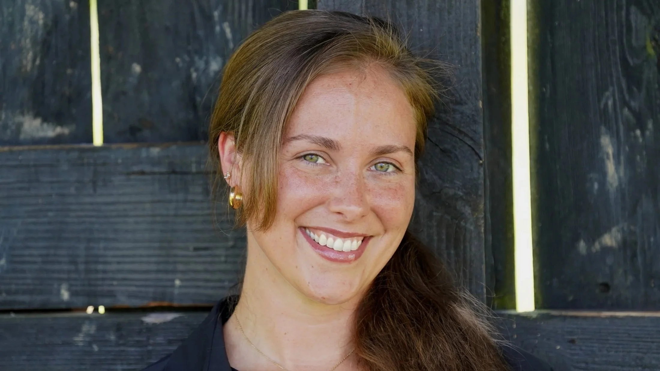 JoHanna Abell, Online Wellness Coach For Women, a close up of JoHanna's face and smiling with ear rings.