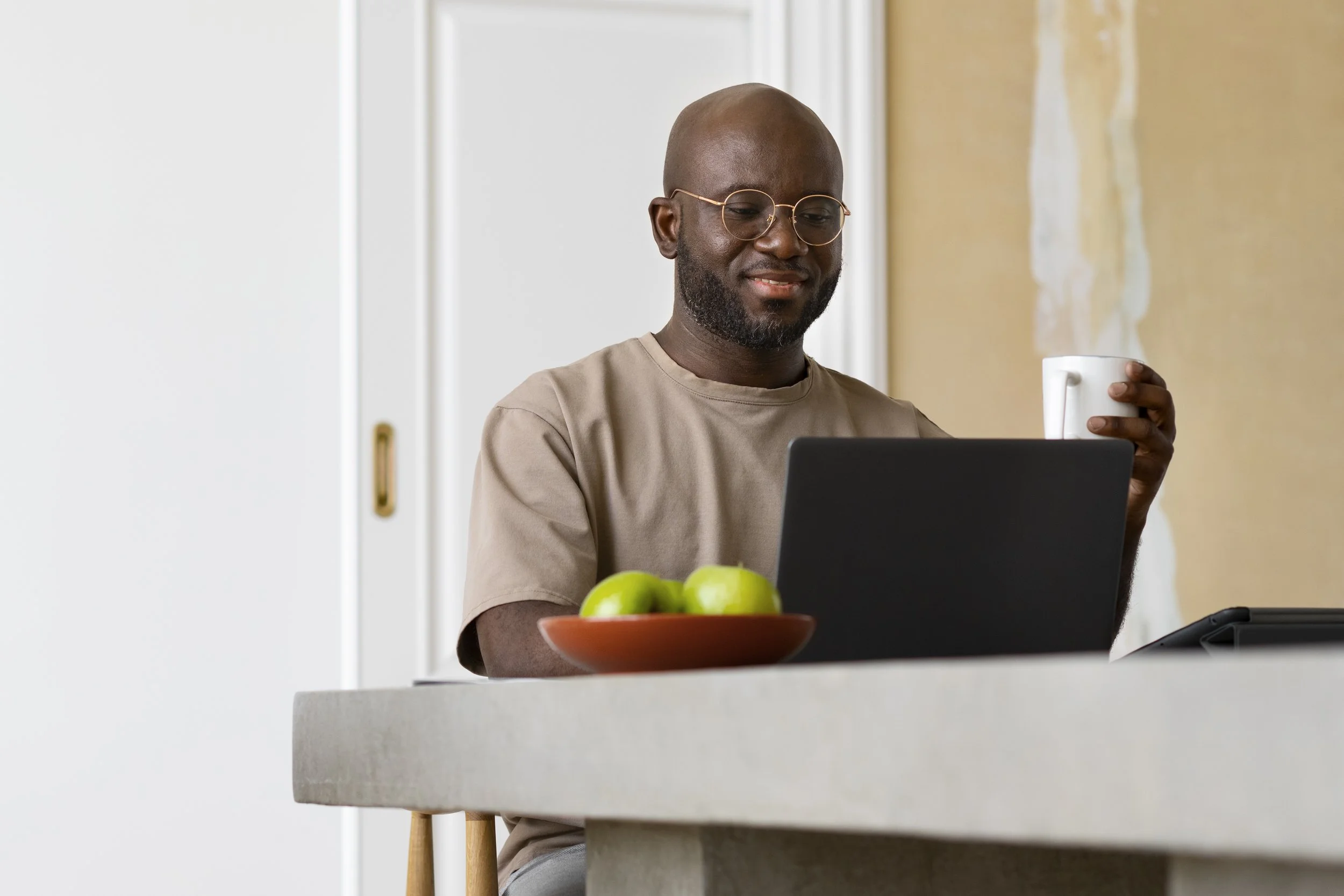 An adult client sitting comfortably at home, participating in a secure online individual therapy session across New Jersey on a laptop.