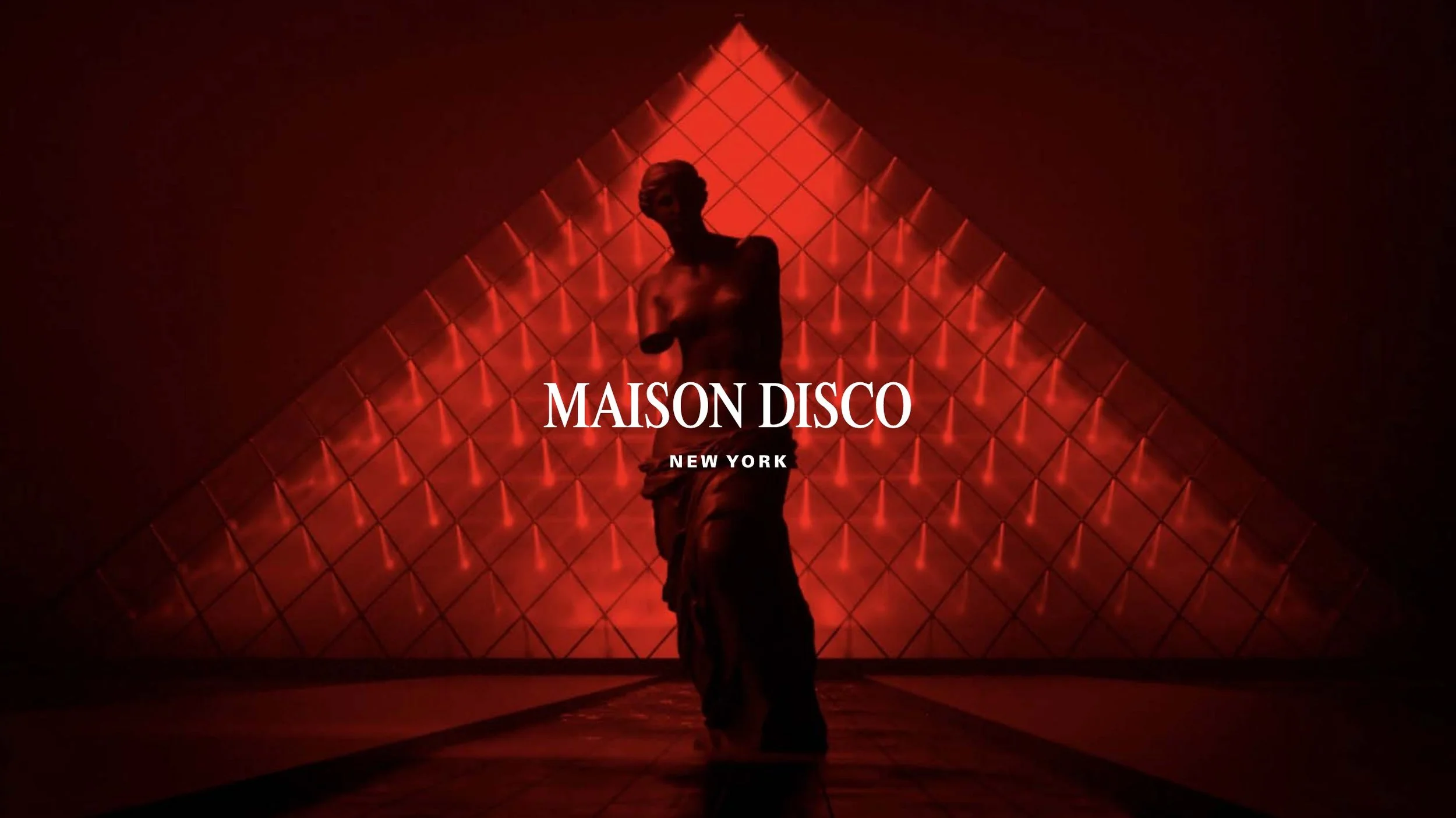 A person standing in front of a red, illuminated geometric wall with the text 'Maison Disco New York.'
