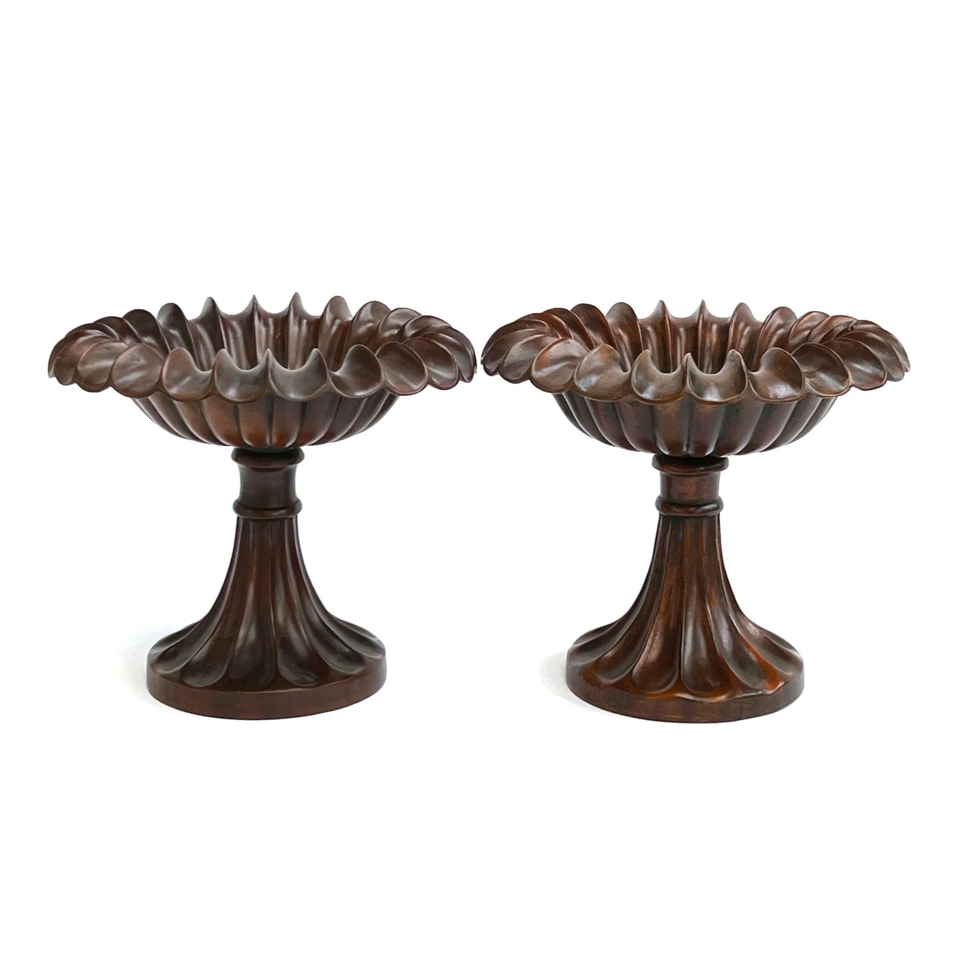 A PAIR OF CARVED TREENWARE TAZZE