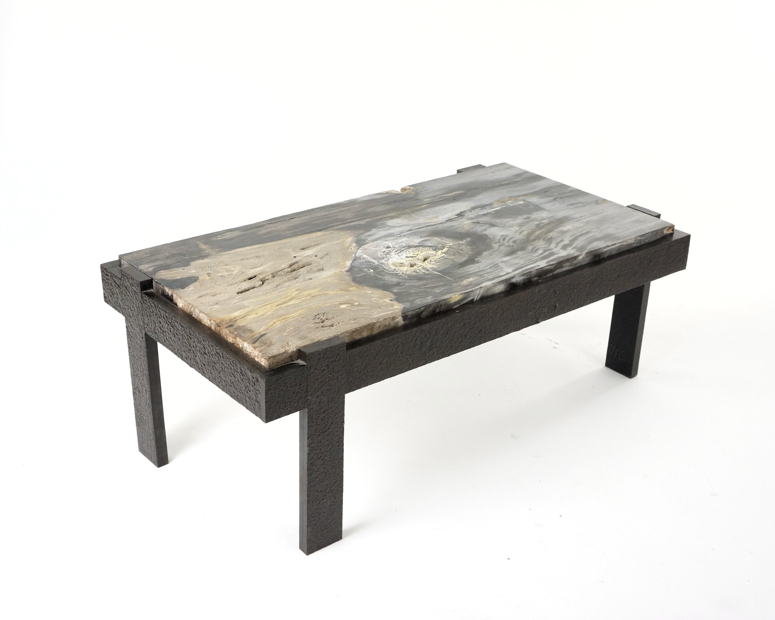 A BRUTALIST PETRIFIED WOOD COFFEE TABLE