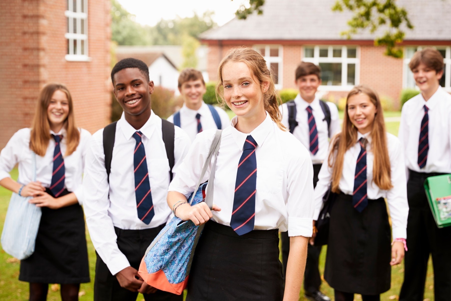 teenagers in school uniforms smiling