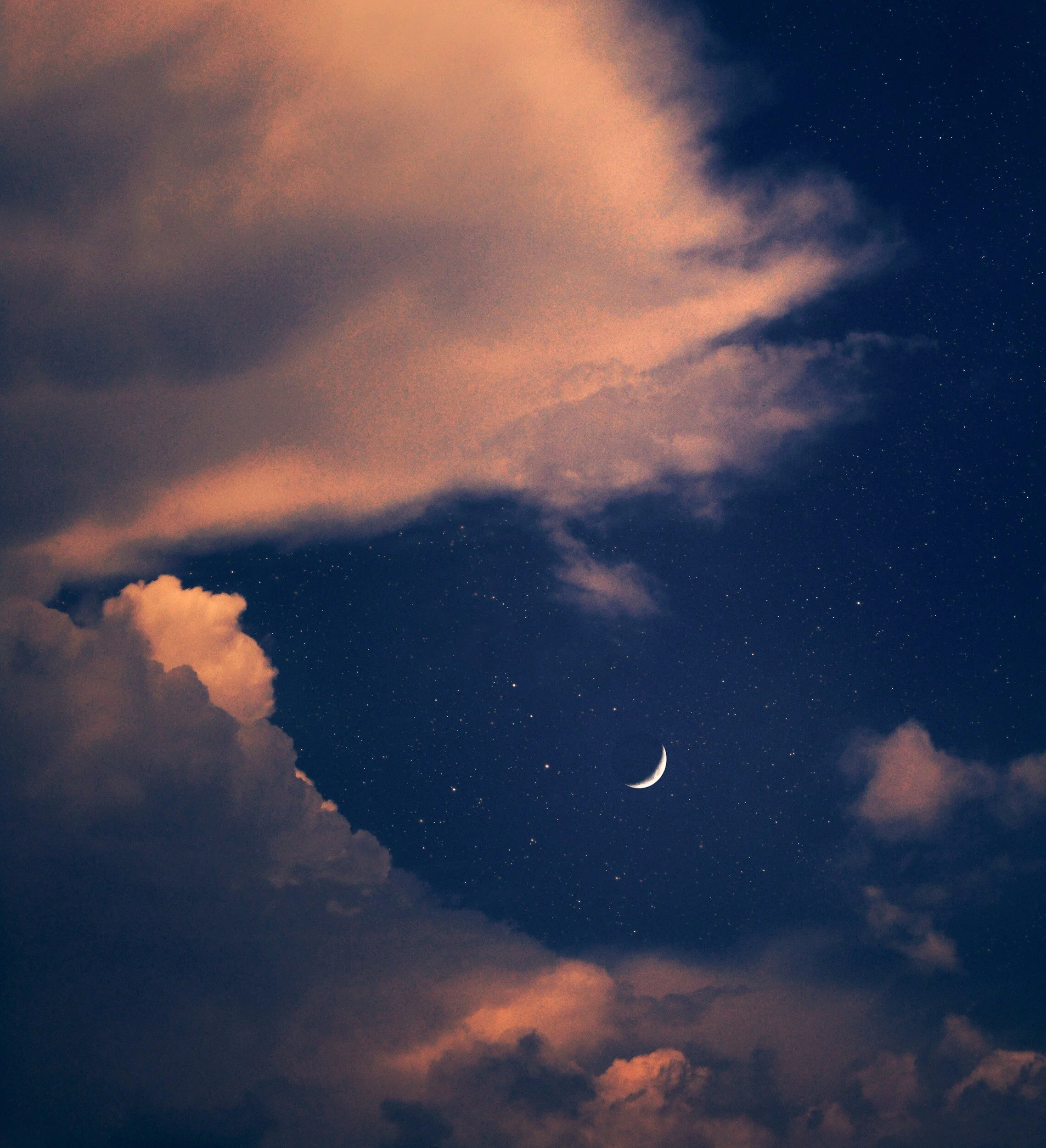 Night sky with a crescent moon, stars, and dark clouds, some with a pinkish hue.