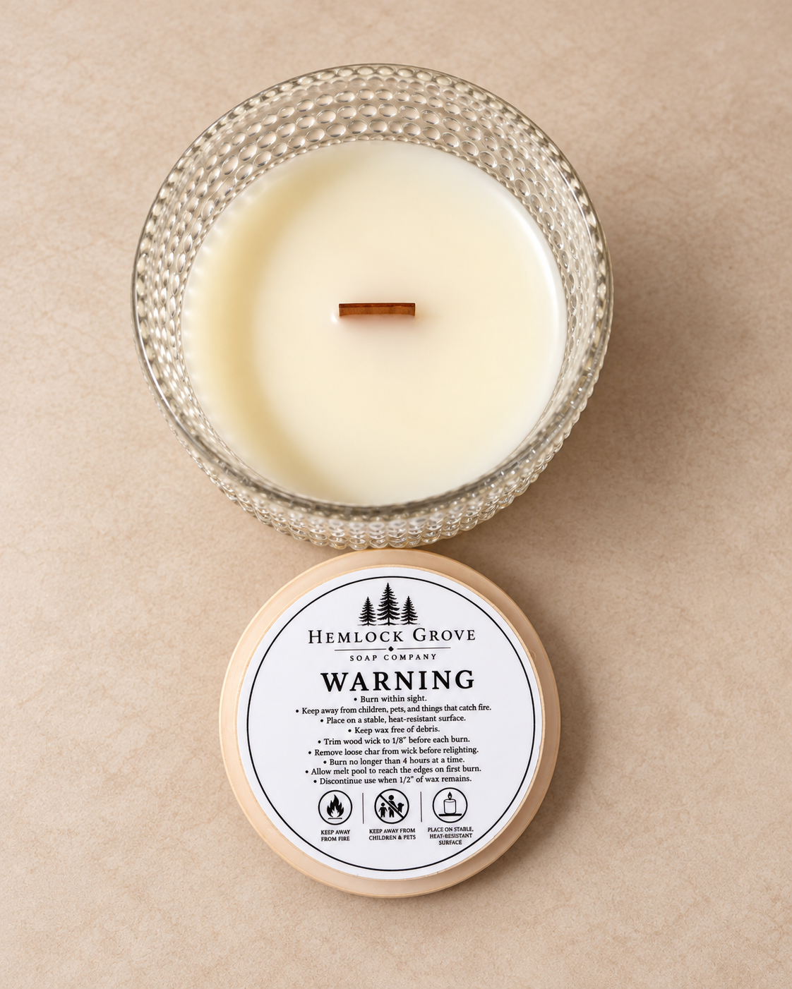 Ro Hus candle showing its maple wood wick and smooth beeswax blend.