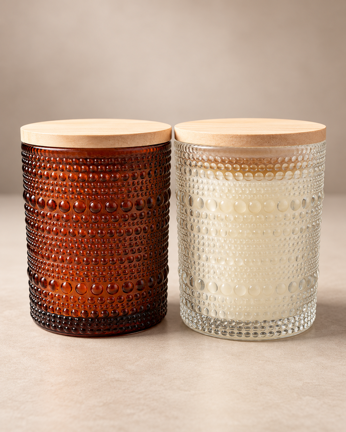 Ro Hus wood wick candle displayed in amber and crystal vessel options.