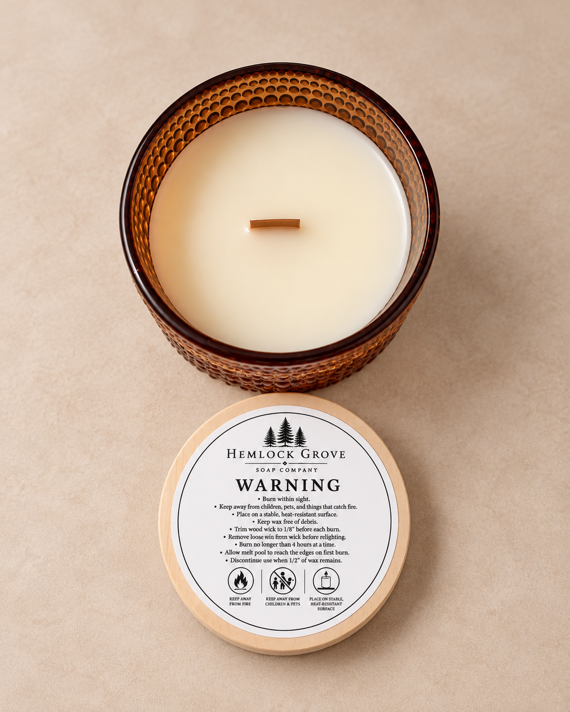 Ro Hus candle showing its maple wood wick and smooth beeswax blend.