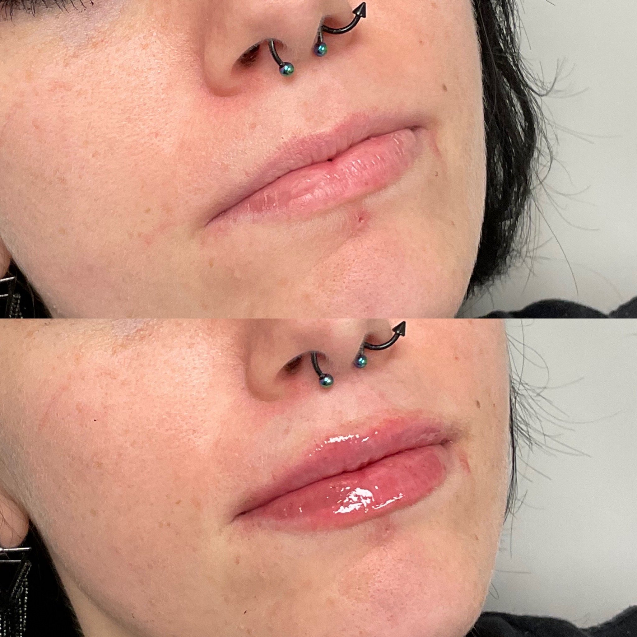 Close-up of a person's face showing lips with shiny lip gloss, nose with a septum piercing featuring two black curved bars with iridescent green beads, and part of their dark hair.