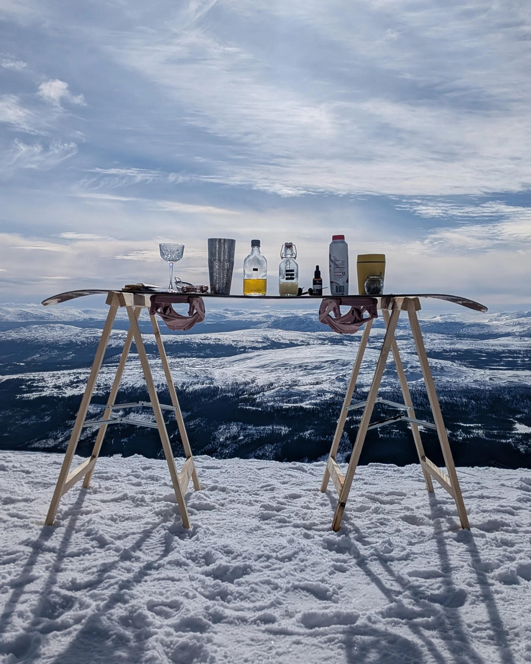 cocktail on a snowboard in Åre with a view over Jämtland. ingredients. shaker, martini