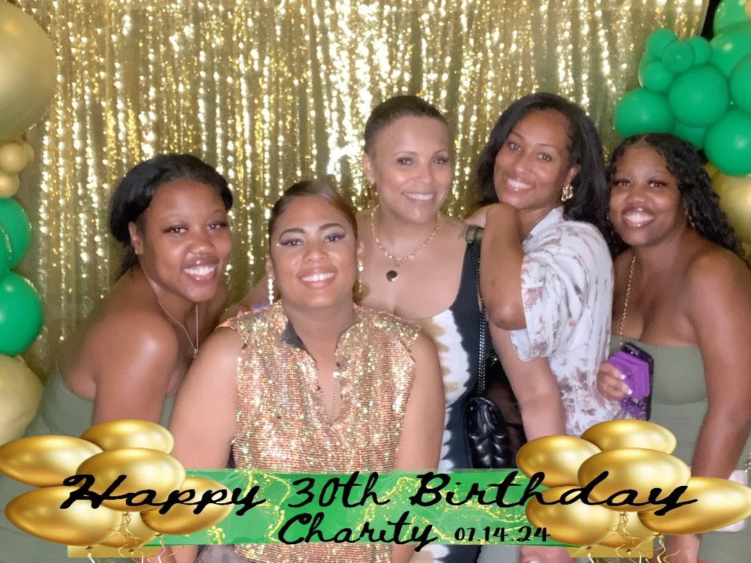 Group of five women smiling at a birthday celebration in front of a gold glitter backdrop with gold and green balloons. Text overlay reads "Happy 30th Birthday Charity 01.14.24" with gold balloon graphics.