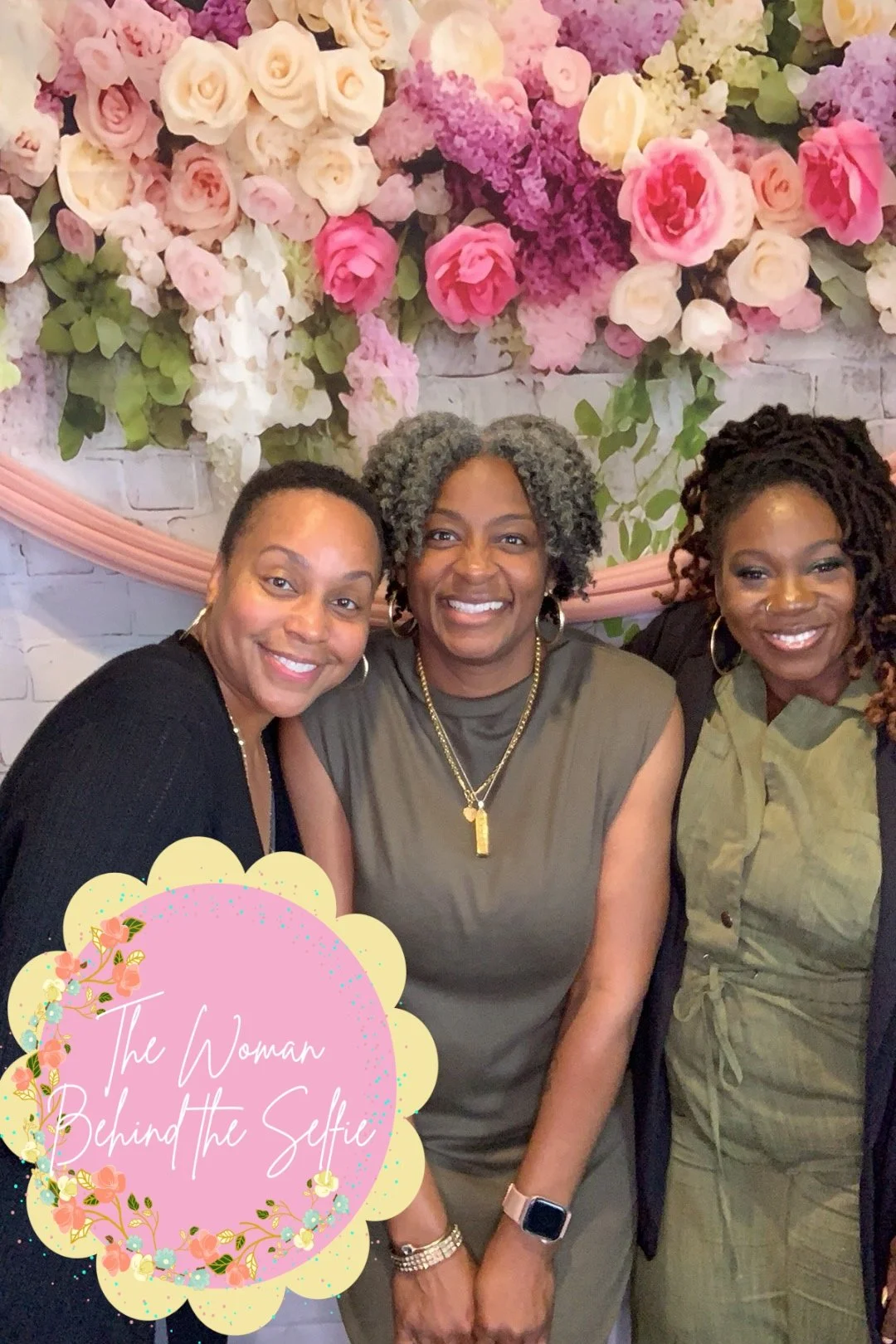 Three women smiling in front of a floral backdrop with pink, white, and purple flowers. A decorative pink and yellow overlay with the text 'The Woman Behind the Selfie' in white cursive.