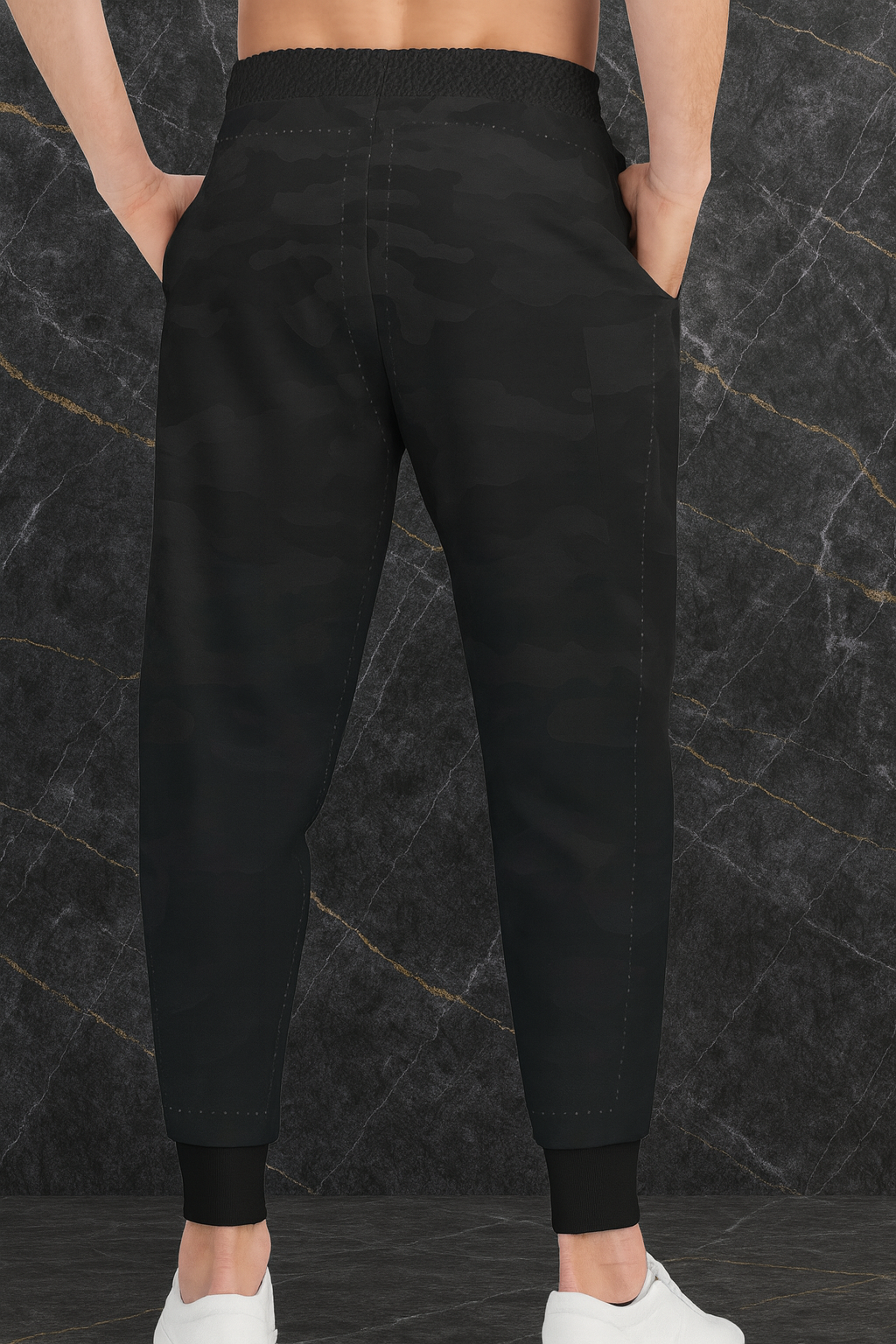 Back view of black camo joggers with elastic waistband.