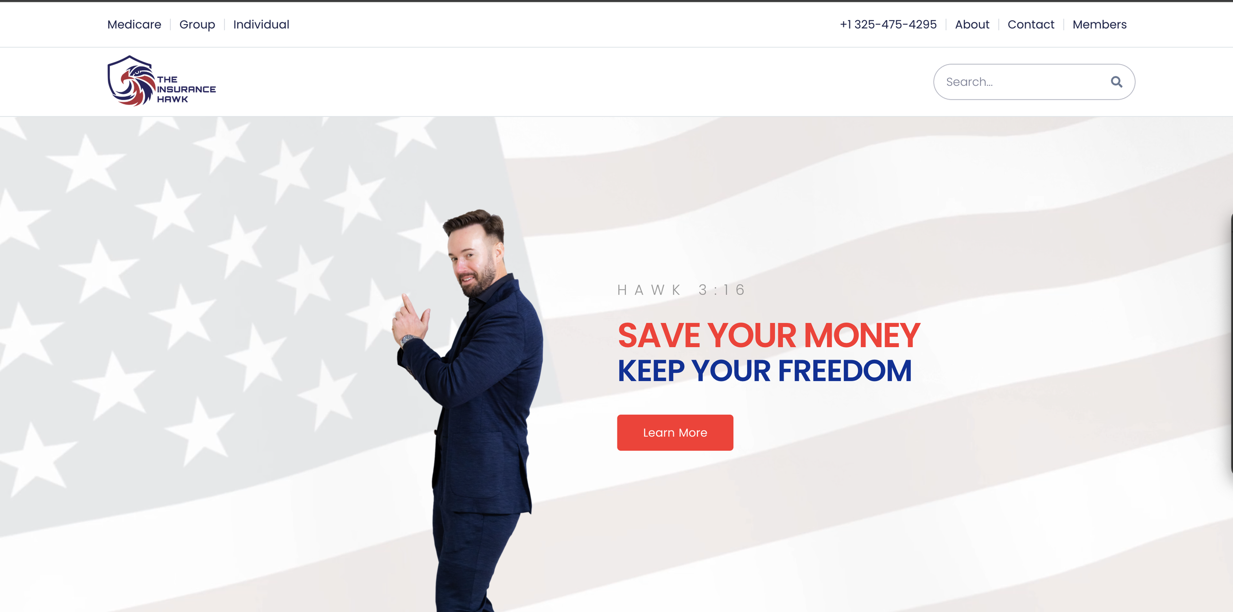 Man in a blue suit standing against a background featuring an American flag with white stars and red and white stripes, pointing with his finger.