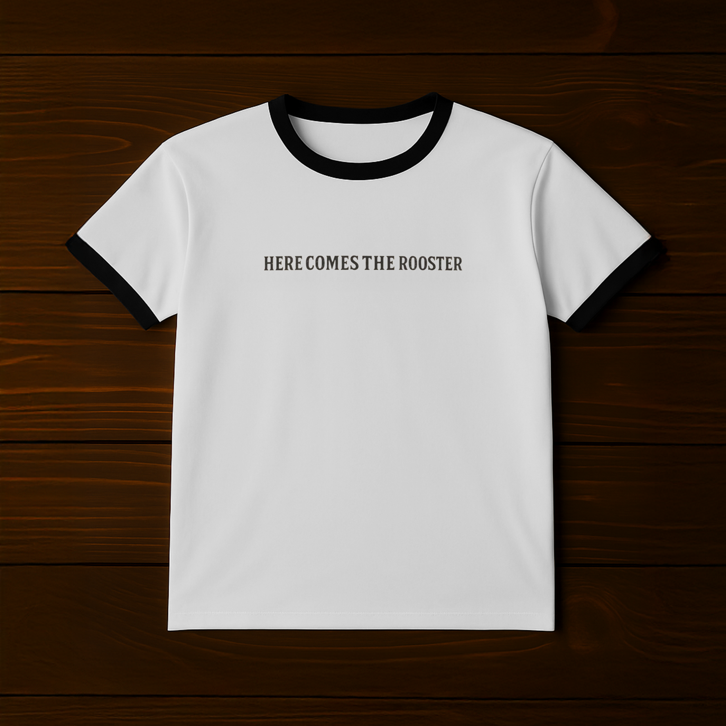Here Comes the Rooster Ringer Tee in white with black collar and sleeves, front text reads Here Comes the Rooster.