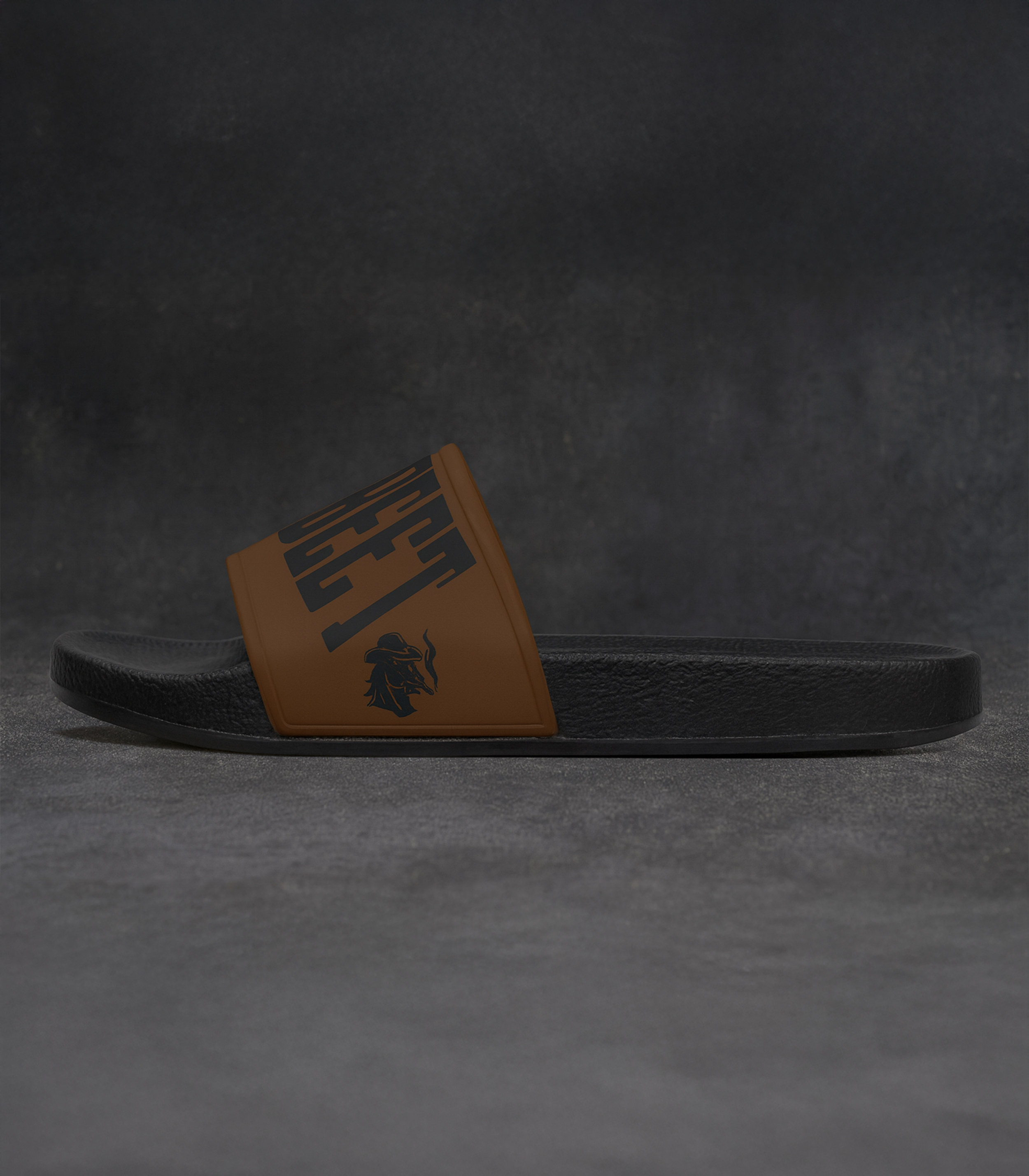 Side view of King Street Cowboys slides on dark background with brown strap logo.