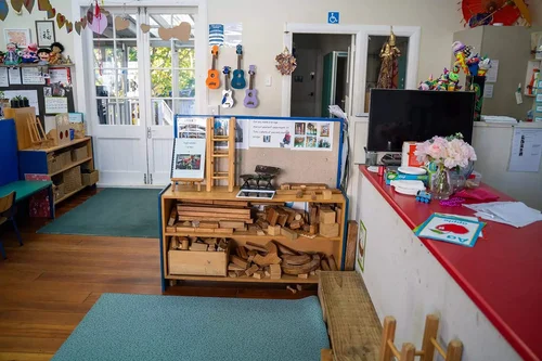 Classroom with wooden toys, puzzles and small guitars on the wall
