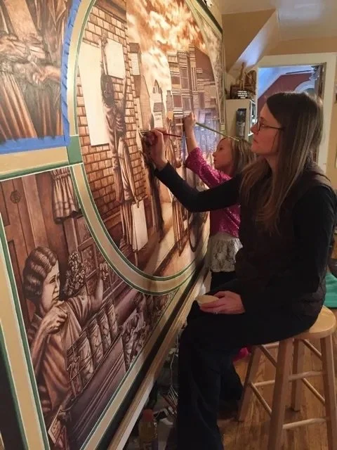 In July, 2014, Hadley pulled out her paintbrushes, ready to bring definition to the first of thirty-three characters that populate the two murals. In the days leading up to the January 7, 2015 mural unveiling, she painted eighteen hours every day. Fo