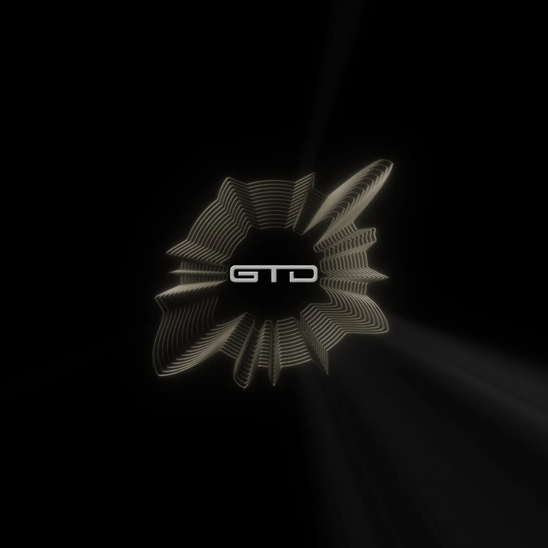 Digital graphic with a central black circle, surrounded by glowing white lines arranged in a star-like pattern, and the letters "GTD" in the middle.