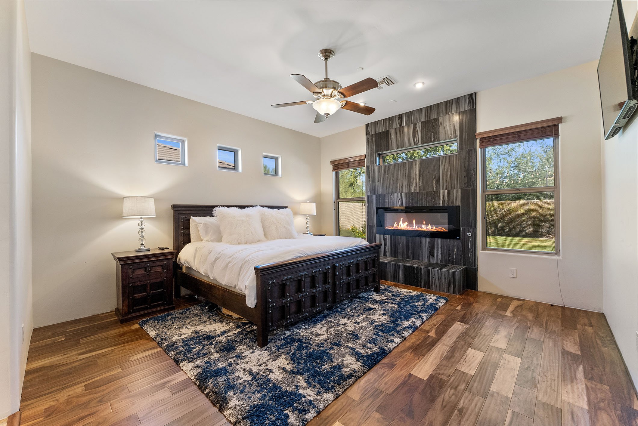 master bedroom with electric fireplace