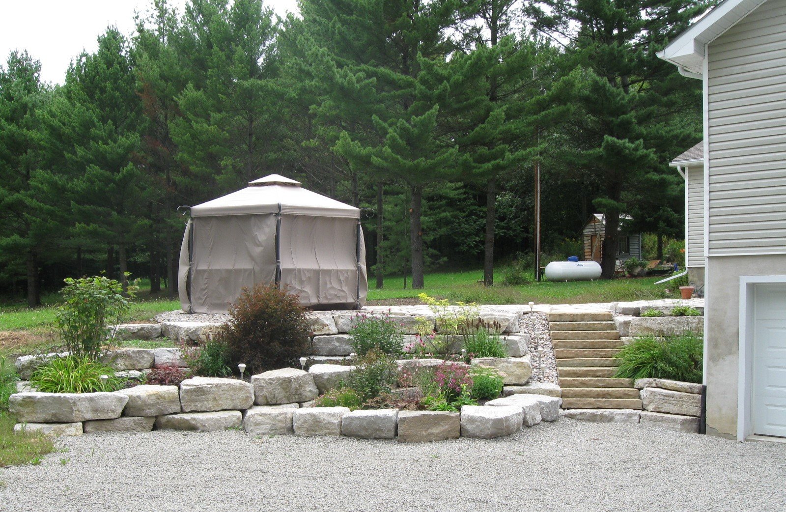 Armour Stone Retaining Wall with Decorative Flower Beds
