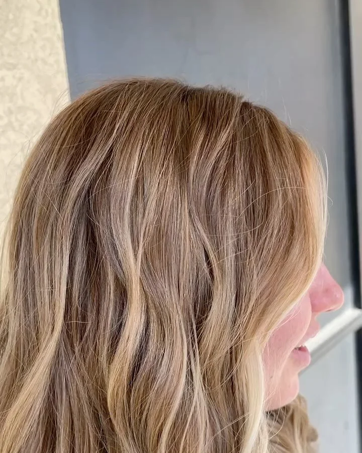 Can you believe how much brighter her blonde looks after we added more depth into her hair?  Our goal was to go a bit more natural after being a very solid blonde for a long time.  This look was created with strategic lowlights, root melt, and all ov