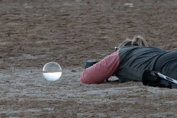 Aimee on the stomach shooting through her crystal ball