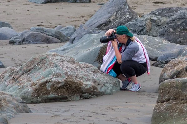 Aimee shooting close up at the beach