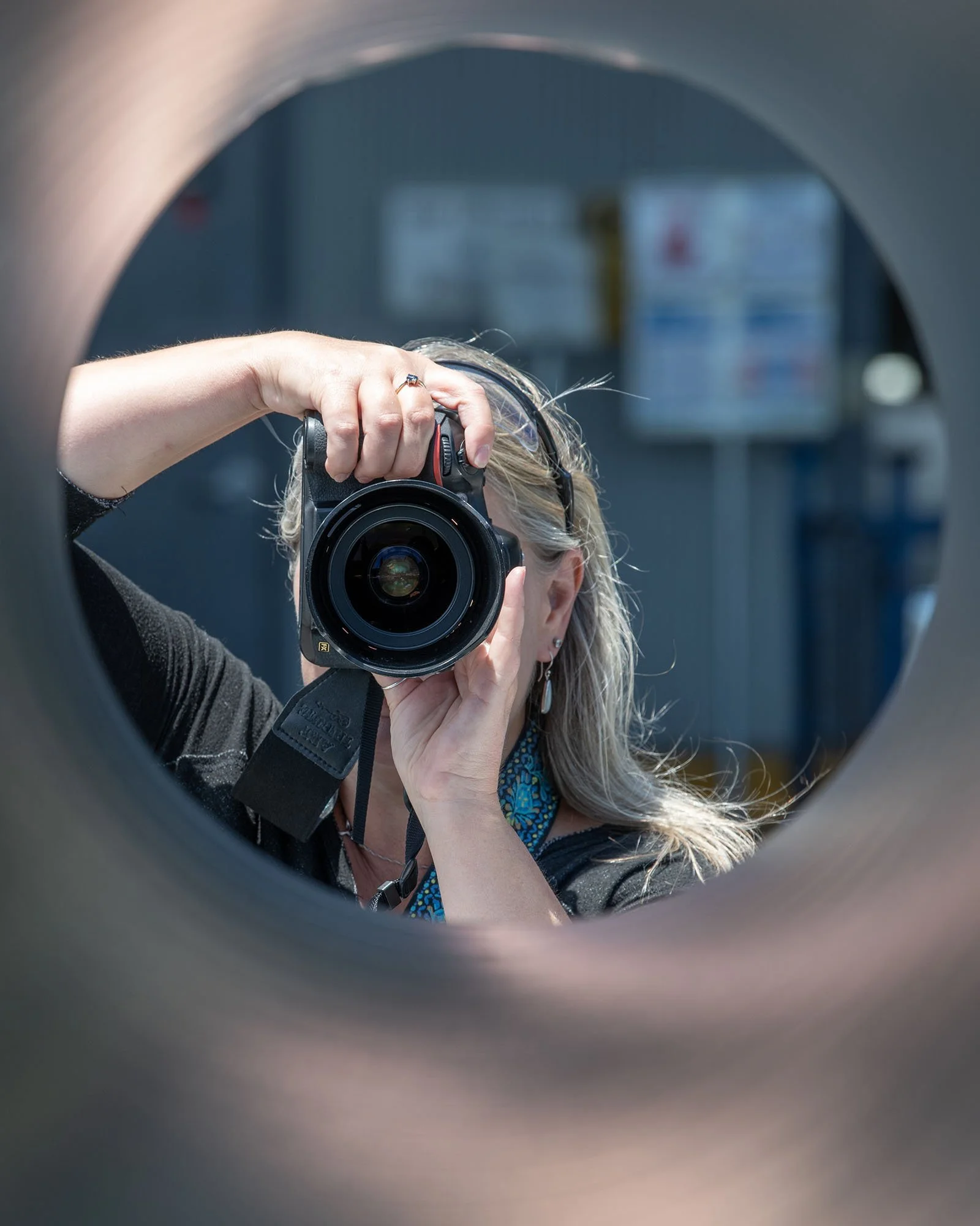 Shooting Aimee with her camera through a pipe
