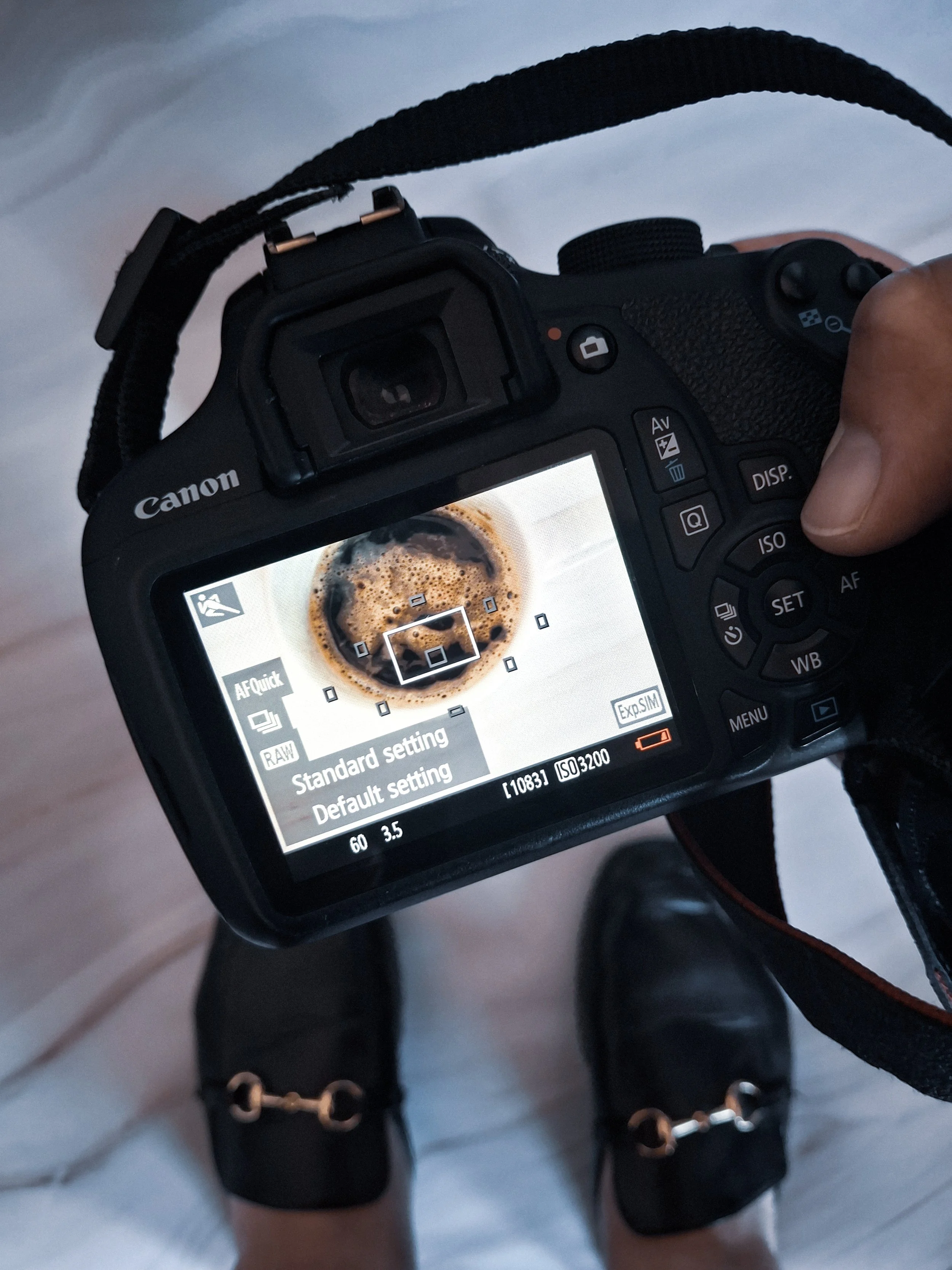 Camera with coffee and shoes