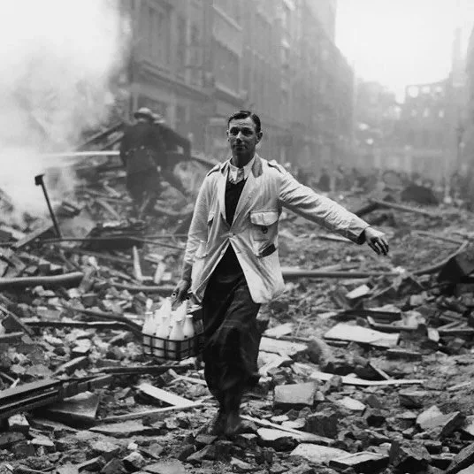 A milkman in the aftermath of the Blitz, when the Luftwaffe targeted British cities between September 1940 to May 1941. The photo was staged as part of the government&rsquo;s drive to get people to carry on as normal, and to adopt a so-called &ldquo;