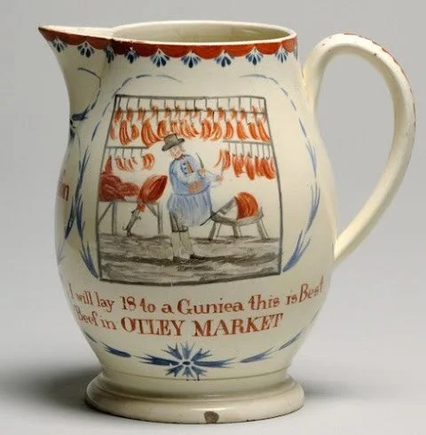 Anyone know where to get the best beef in Otley Market? This is a wonderful example of a creamware jug from 1802, presumably commissioned by a butcher who sold wares at Otley Market in West Yorkshire, England. The market was established in 1222 and s