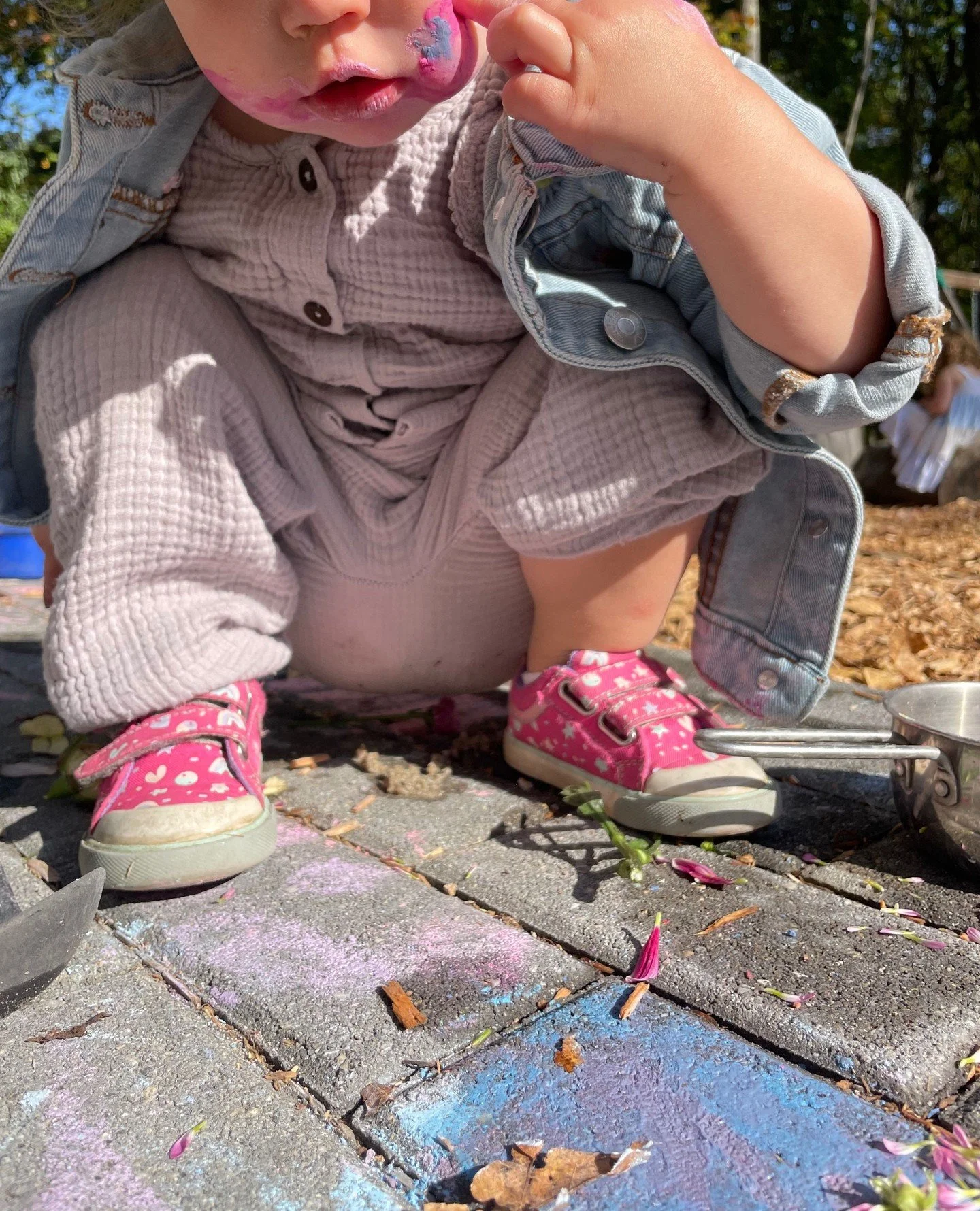 A hand pressed into chalk dust and flower petals becomes a sensory masterpiece. ⁠
⁠
Through this type of play, children explore textures, colors, and cause-and-effect relationships &mdash; laying the foundation for scientific thinking while sparking 