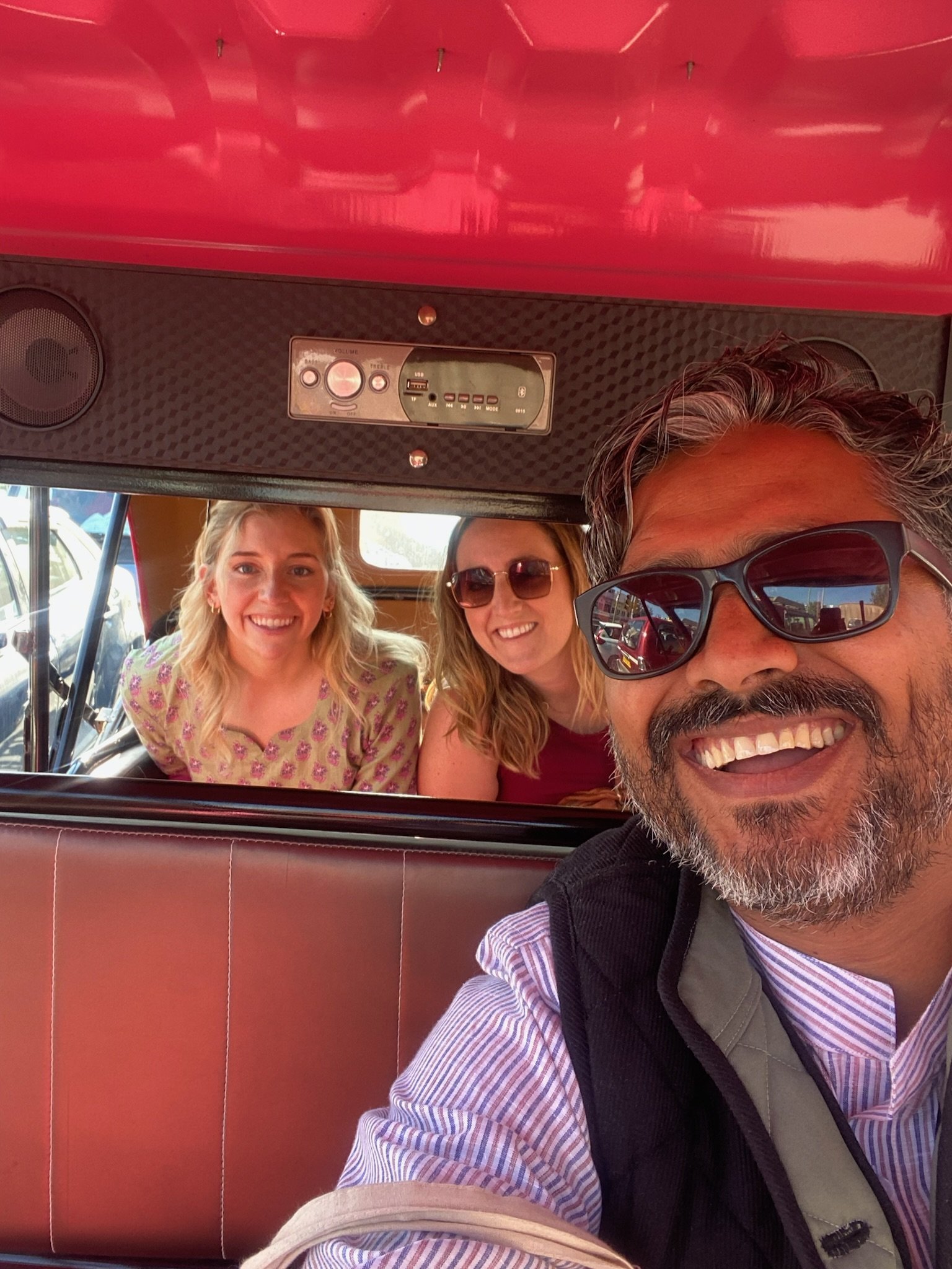 Two women in the backseat of a Pink City Rickshaw