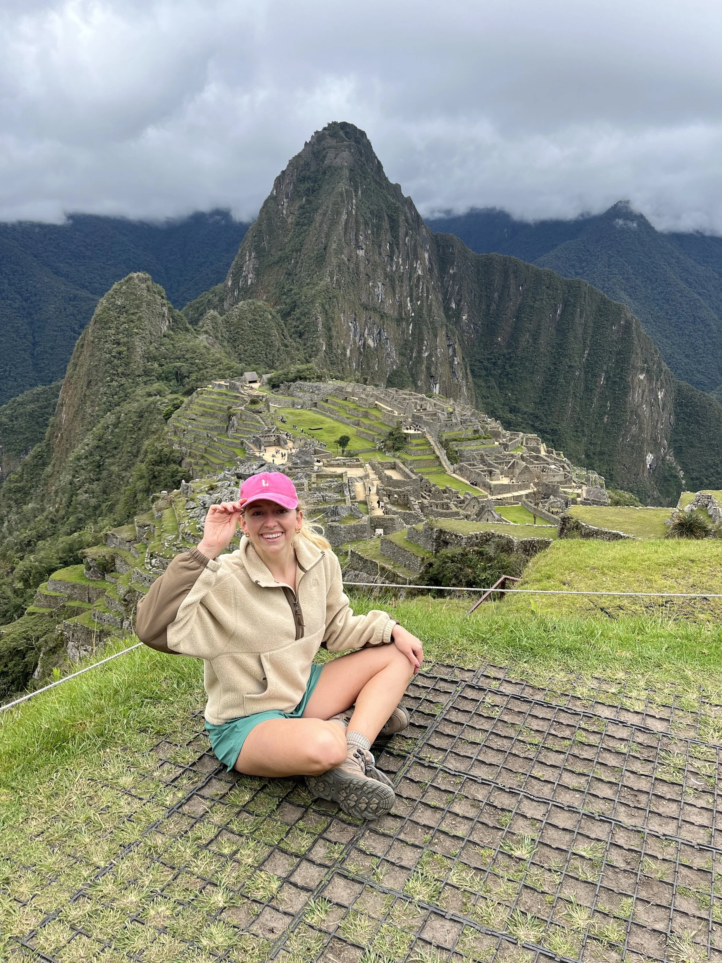 Woman sitting in front of Machu Picchu
