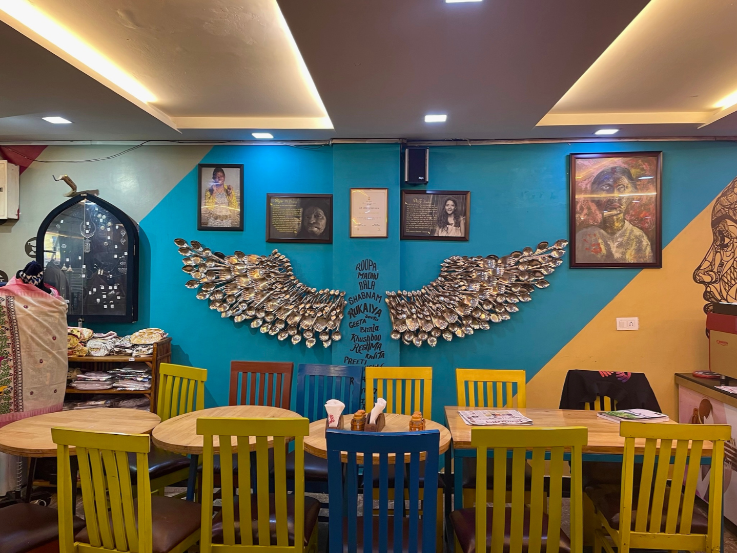 Sheroes Hangout interior cafe tables photos of acid attack survivors