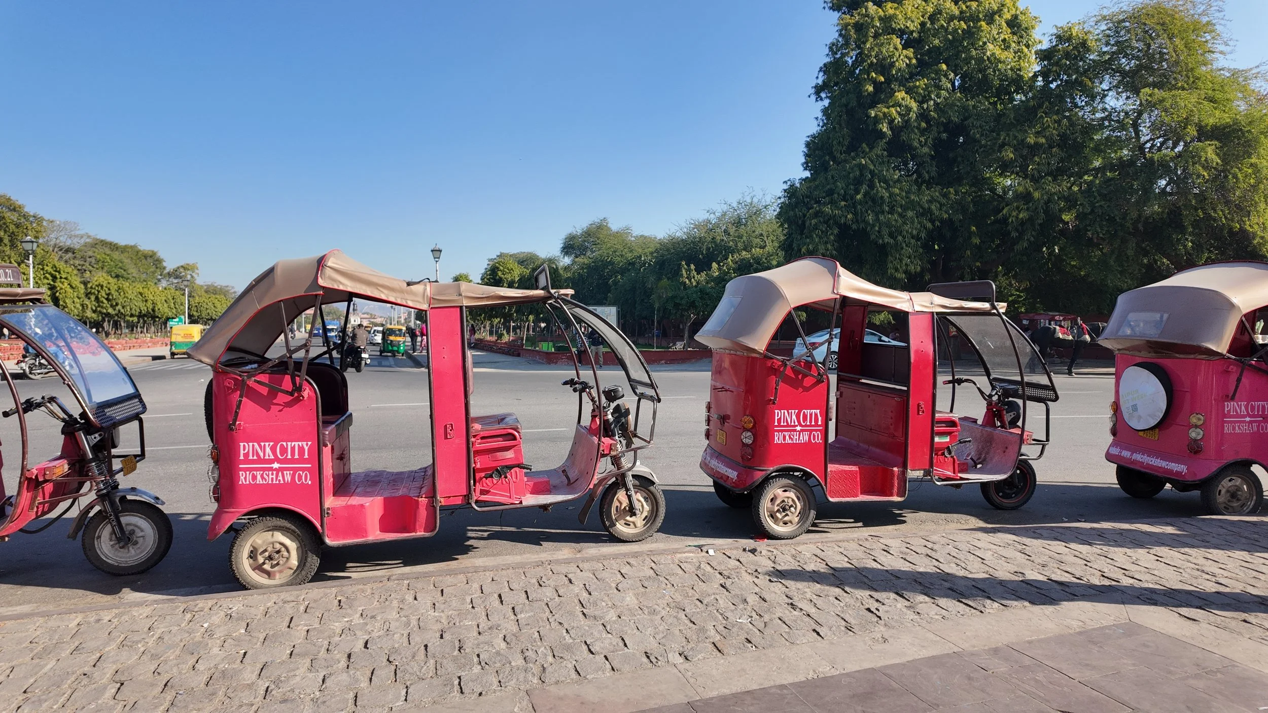 Fleet of hot pink rickshaws.