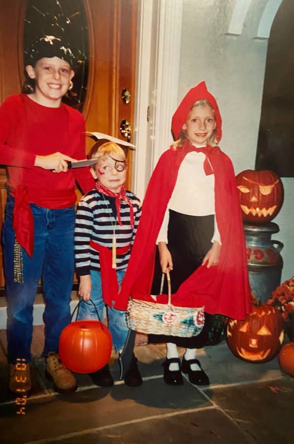 Three kids dressed up for Halloween. Girl: pirate Boy: pirate Girl: Little red riding hood