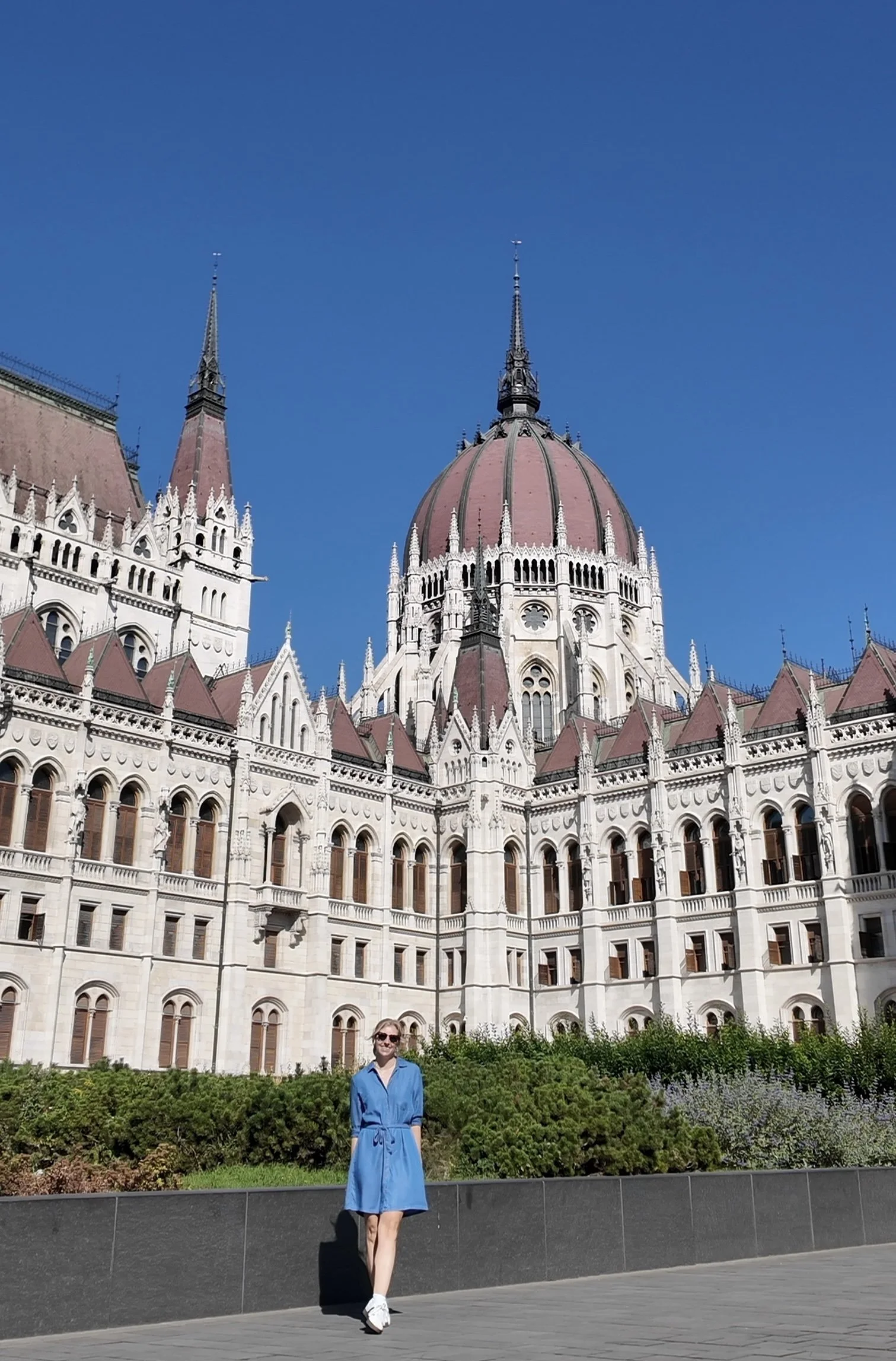 Woman standing in front of Hungarian Parliament Building in Budapest
