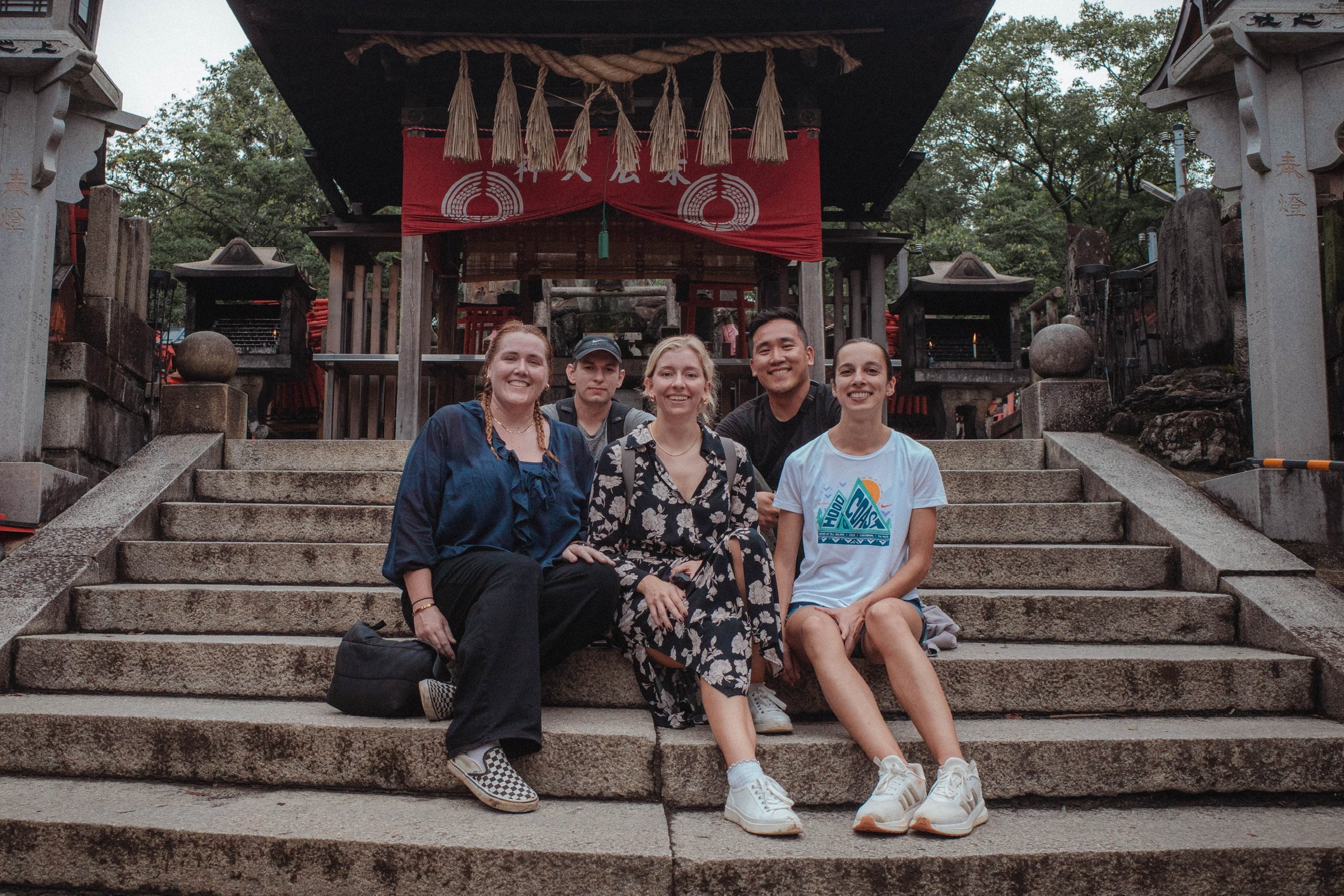 Group of people sitting in front of Fushimi Inari shrine in Kyoto, Japan