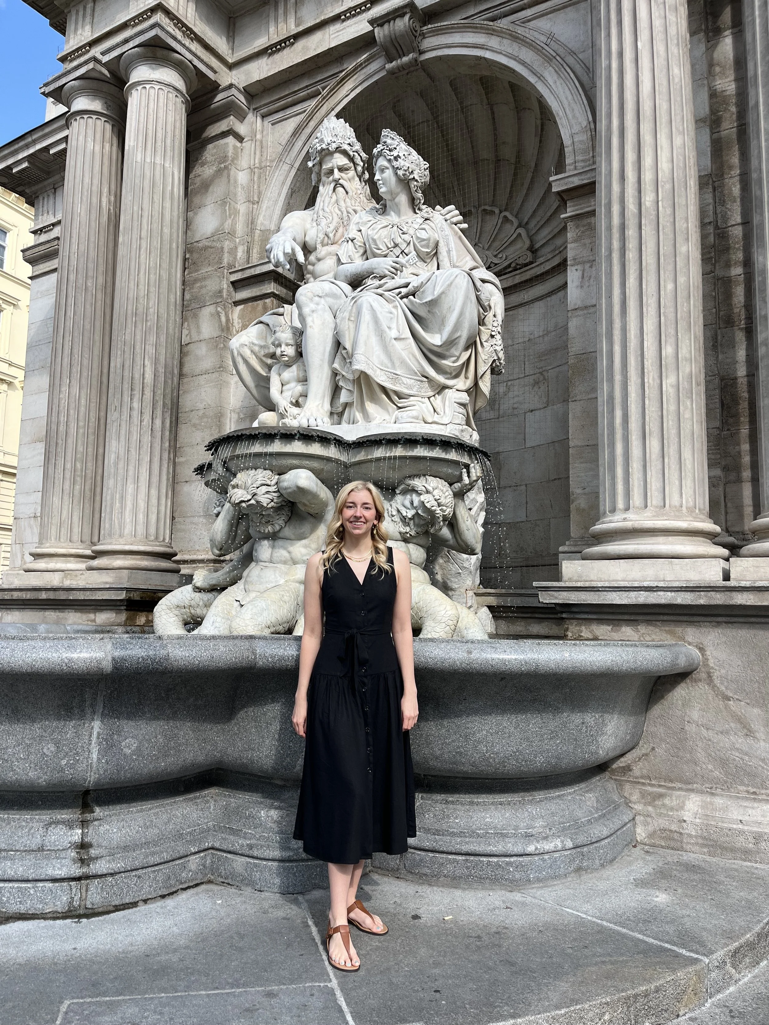 Woman standing in front of fountain in Vienna