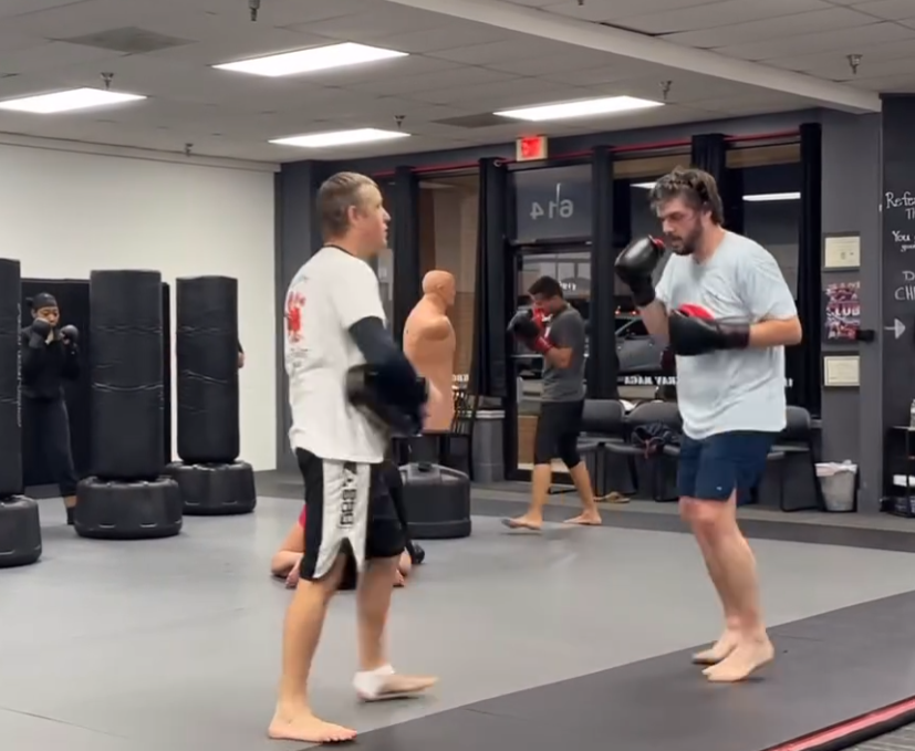MMA training class at Fight Club Fitness in Birmingham, Alabama, showing a coach working striking drills with a student during mixed martial arts practice.