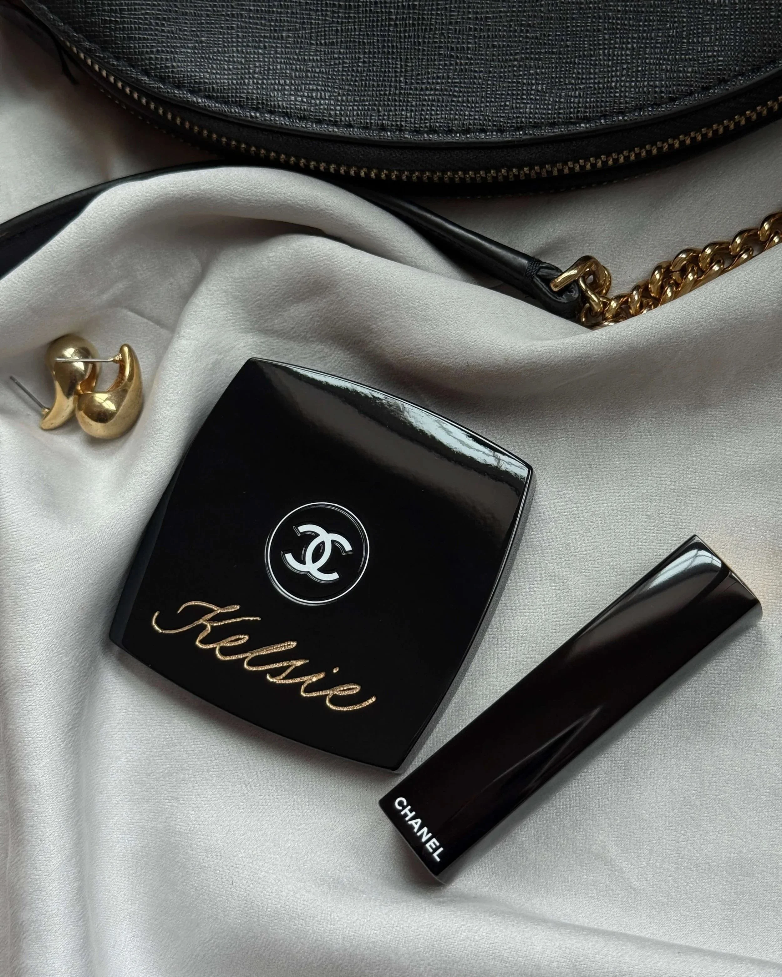 Custom engraved Chanel compact mirror inscribed with bridesmaid's name in gold lettering and elegant calligraphy style. 