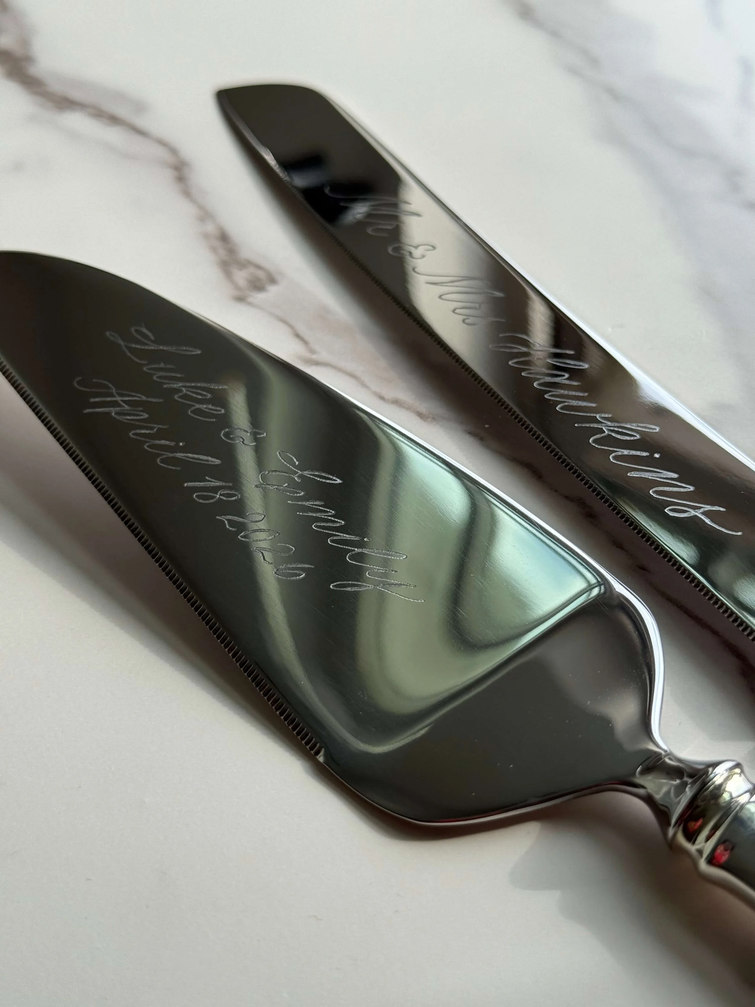 Custom hand engraved Tiffany and Co. wedding cake cutting set, inscribed with couple's names and wedding date in an elegant calligraphy style.
