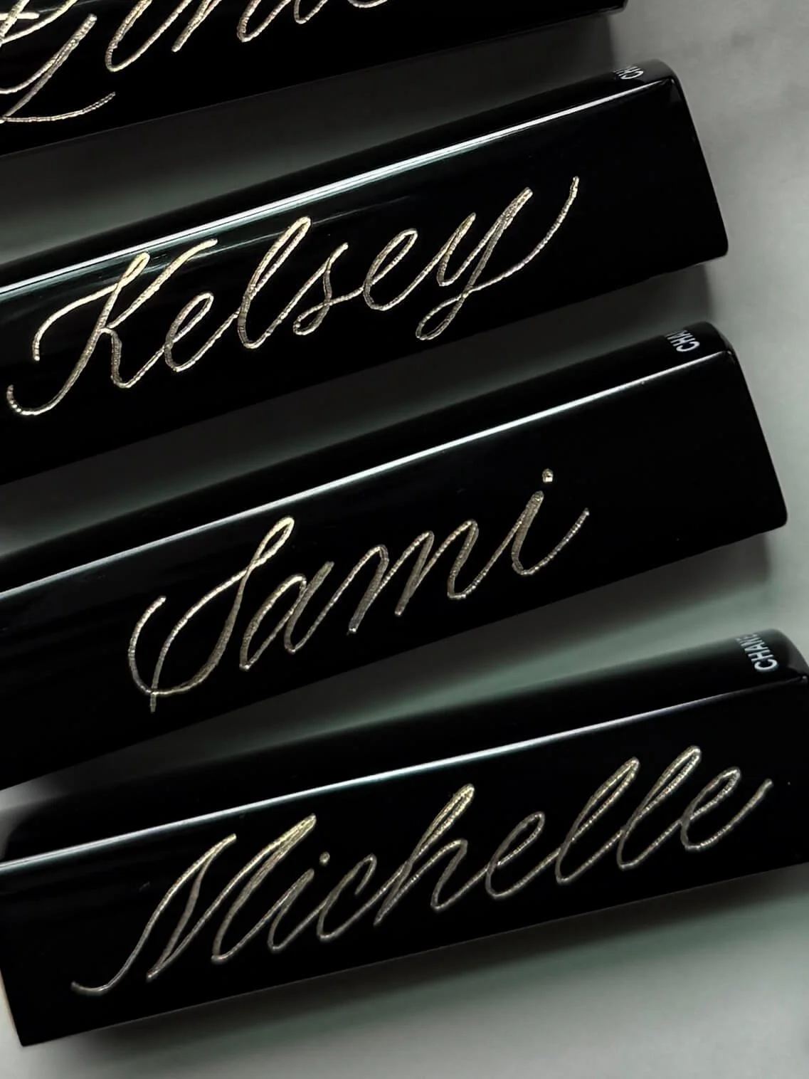 Hand-engraved Chanel lipsticks with custom names, creating elegant personalized bridesmaid gifts and luxury keepsakes for weddings and events.