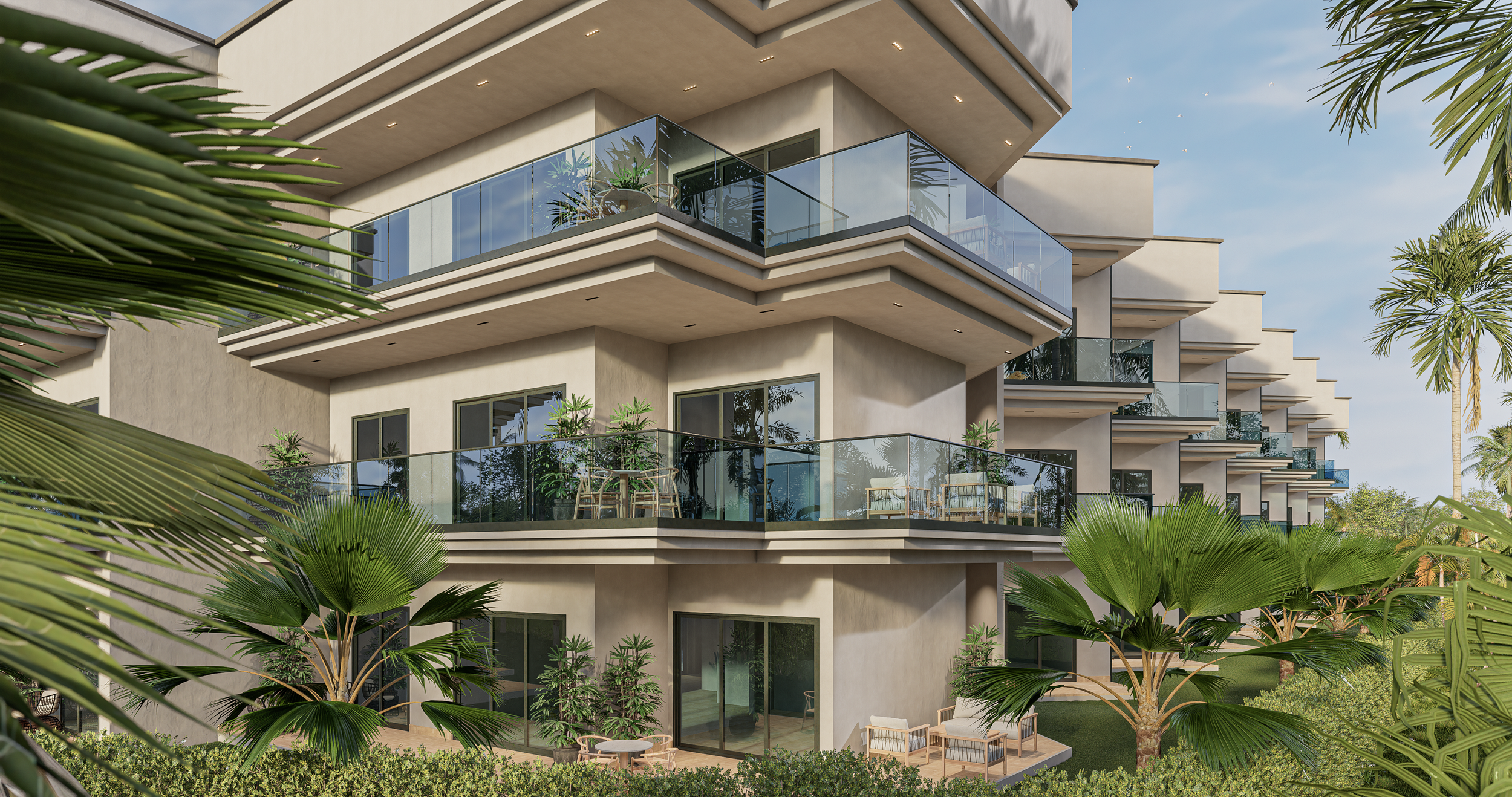 Three-story modern residential building with glass balconies, surrounded by green palm trees and landscaping, under a blue sky.