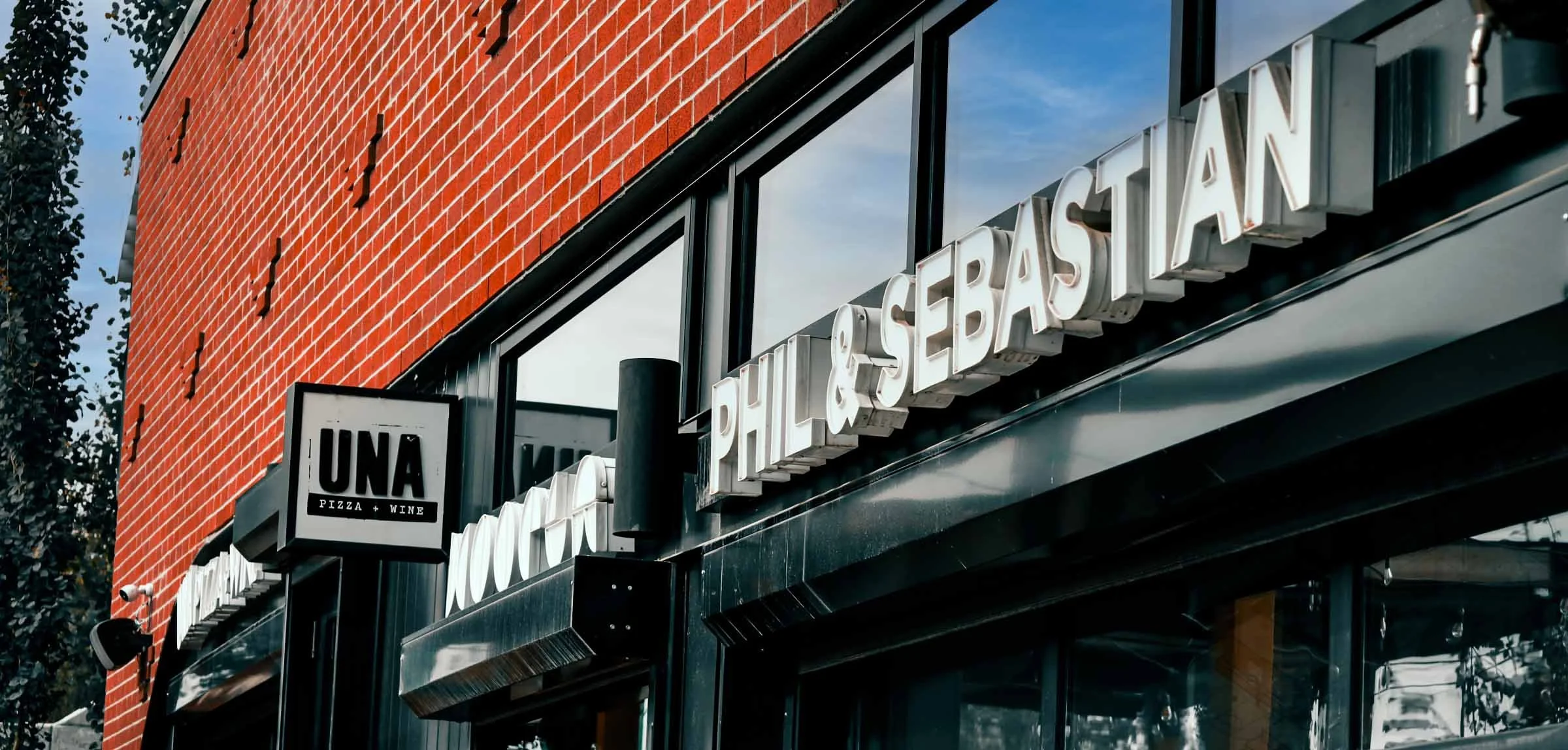 Commercial architectural photography of Phil & Sebastian and UNA Pizza signage in Bridgeland, Calgary.