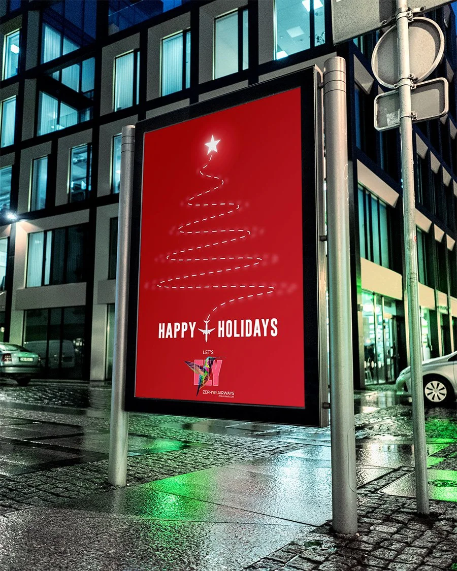 A festive red billboard displays a minimalist white Christmas tree outline topped with a star. Text reads 'HAPPY HOLIDAYS' and 'LET'S' with a colorful, patriotic-themed airplane logo of Zephyr Airways at the bottom, set against a city street scene at night with wet pavement and surrounding buildings.
