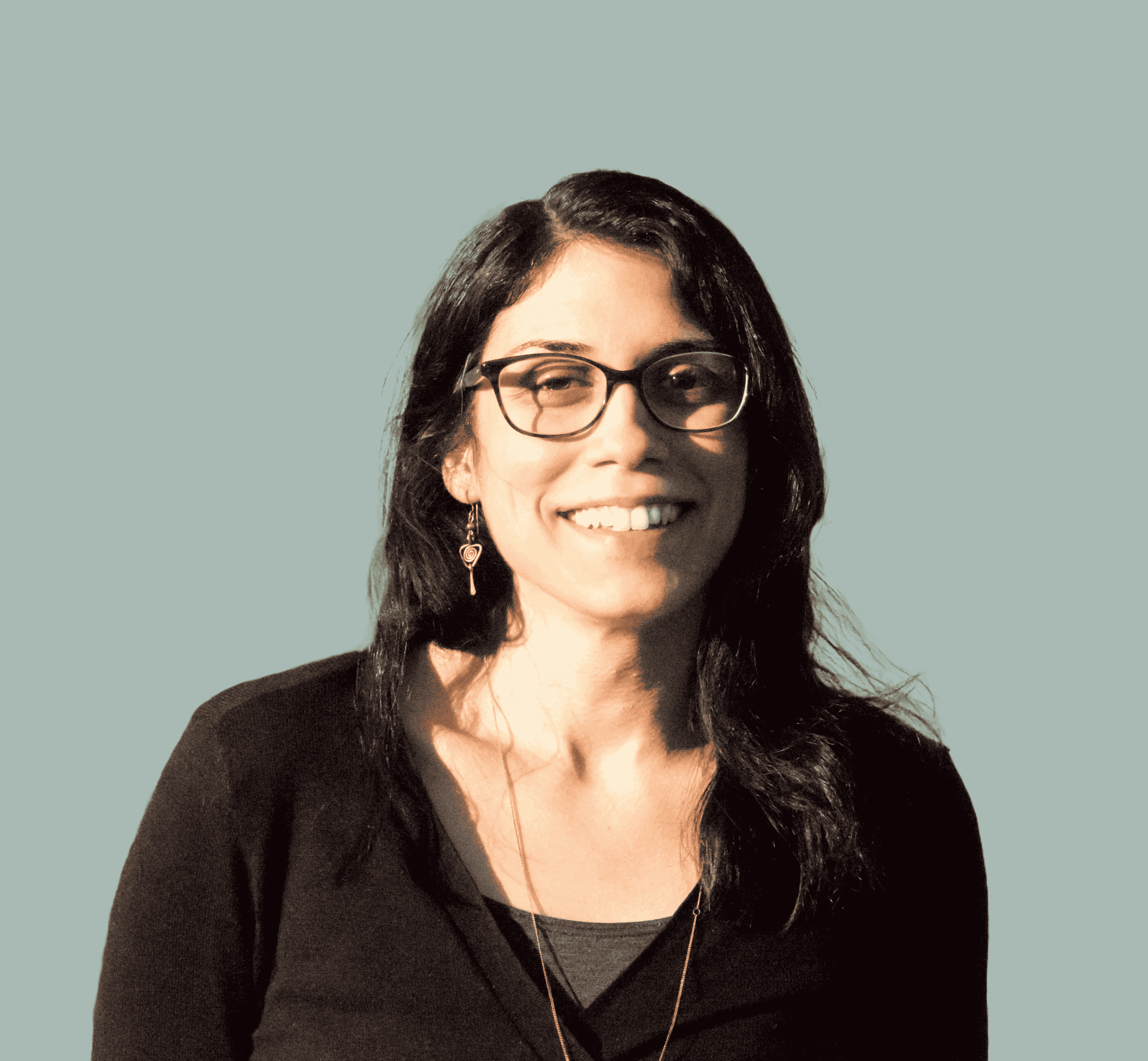 Carina Tudor-Sfetea, BABCP-accredited CBT therapist and mindfulness teacher for high-achieving introverts, smiling on a light teal background