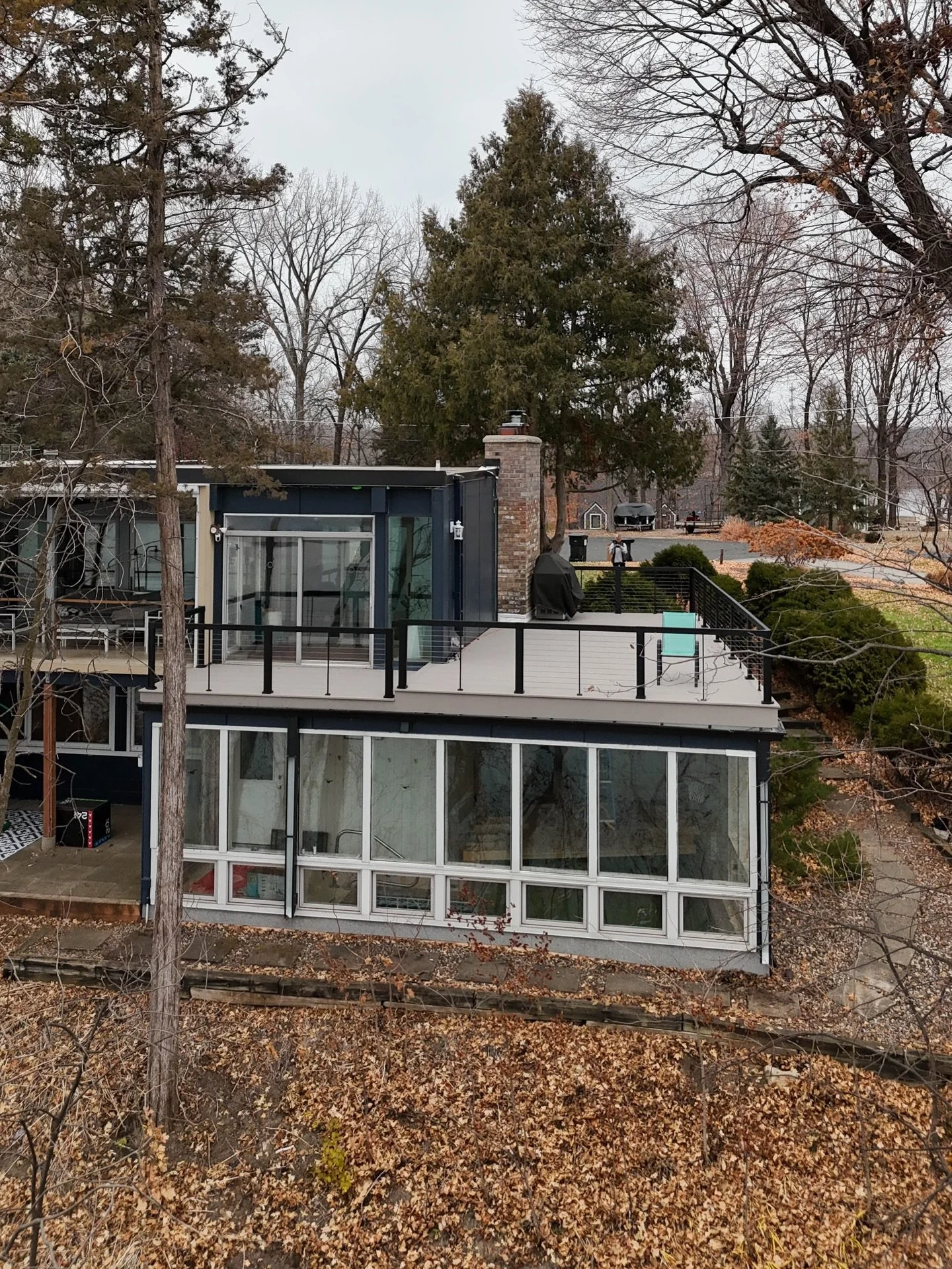 An MCM masterpiece&mdash; overlooking a beautiful lake! We went with @timbertech Slate Gray - Advanced PVC Harvest decking and @rdirail cable railing for a modern look for this deck!